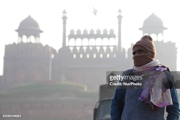 Man wears full face mask stands infront of the Red Fort amid heavy fog in Delhi on 6 November 2018.