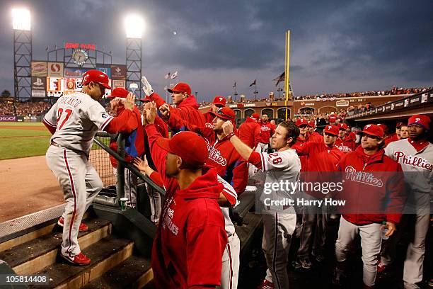 Placido Polanco of the Philadelphia Phillies celebrates in the dugout after scoring against the San Francisco Giants in the fifth inning of Game Four...