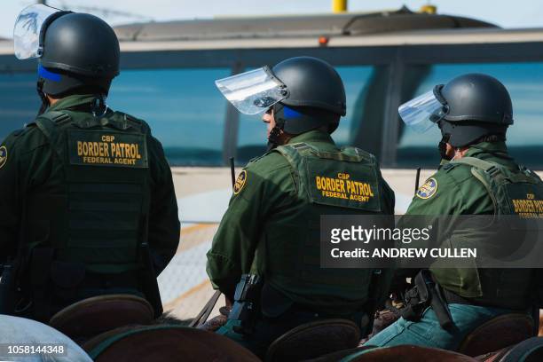 Customs and Border Protection agents participate in a training exercise at a vehicle entry point along the border with Mexico on November 5 in...