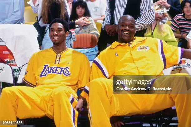 Kobe Bryant and Shaquille O'Neal of the Los Angeles Lakers sit on the bench during a game circa 1998 at the Great Western Forum in Inglewood,...
