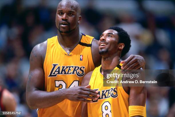 Kobe Bryant and Shaquille O'Neal of the Los Angeles Lakers walk and talk during a game played circa 2000 at the Staples Center in Los Angeles,...