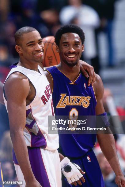 Kobe Bryant of the Los Angeles Lakers and Vince Carter of the Toronto Raptors look on during a game played circa 2000 at the Staples Center in Los...