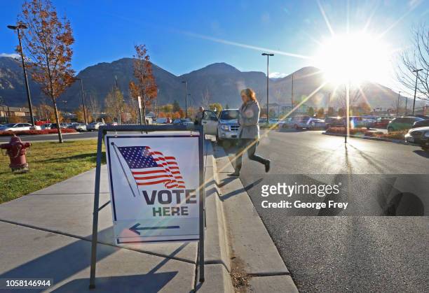 November 6: A woman walks into a polling center to vote in the midterm elections as the morning sun rises over the Utah Wasatch Mountains on November...