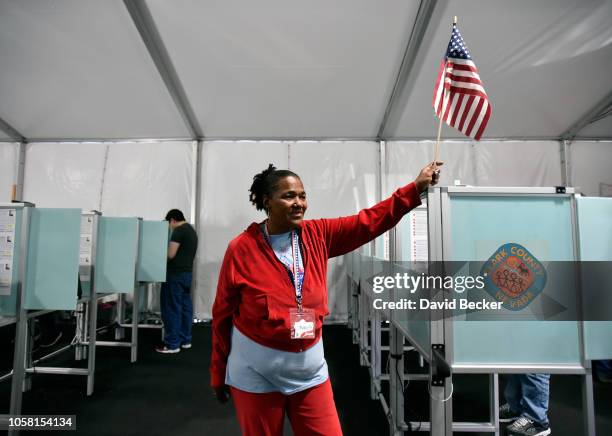 Election worker Robin Wright guides voters to available voting machines on November 6, 2018 in Las Vegas, Nevada. Turnout is expected to be high...