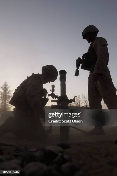 Marines Cpl. Dave Needham from Fruita, CO and Cpl. Christopher Arnold of Crownsville, MD with India Battery, 3rd Battalion, 12th Marine Regiment...