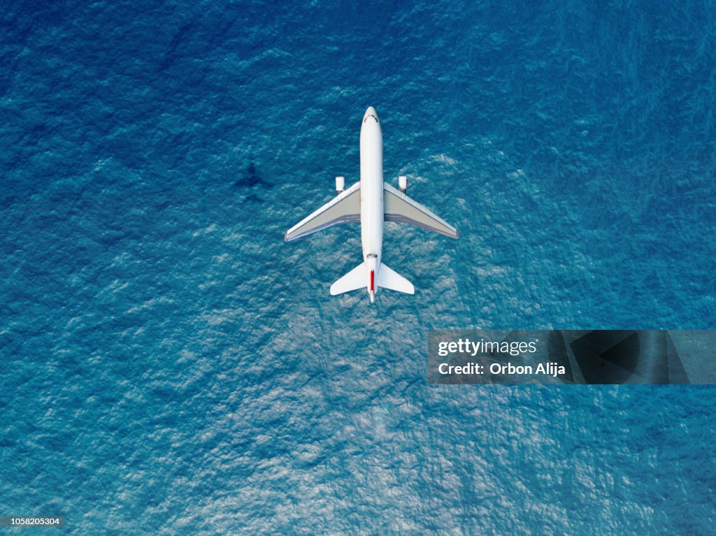 Airplane flies over a sea