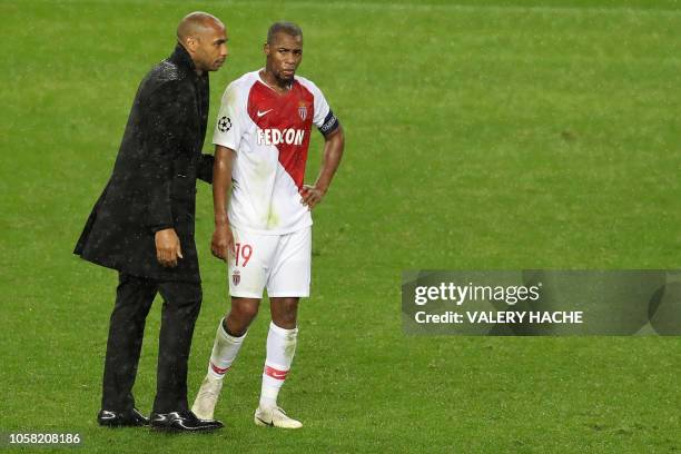 Monaco's French coach Thierry Henry comforts Monaco's French defender Djibril Sidibe after being defeated 4-0 by Brugge at the end of the UEFA...