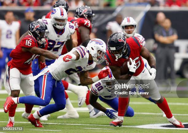 Lamar Miller of the Houston Texans rushes past Rafael Bush of the Buffalo Bills at NRG Stadium on October 14, 2018 in Houston, Texas.