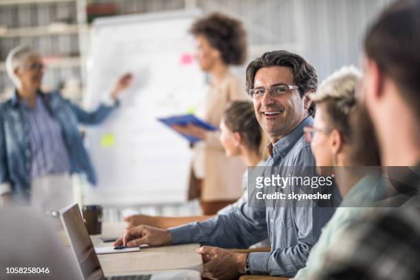 happy businessman during a presentation in the office. - mid adult men stock pictures, royalty-free photos & images