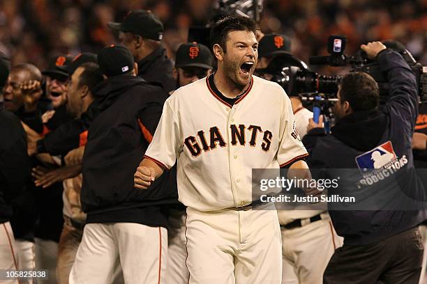 Freddy Sanchez of the San Francisco Giants celebrates after a sacrifice fly by Juan Uribe scored Aubrey Huff to win the game 6-5 over the...