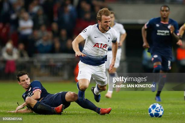 Eindhoven's Dutch defender Nick Viergever fouls Tottenham Hotspur's English striker Harry Kane during the UEFA Champions League group B football...