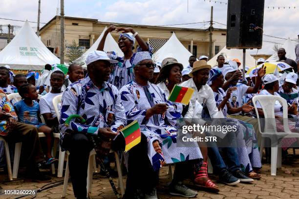 Supporters of Cameroonian President Paul Biya wear clothing emblazoned with his image as they celebrate his re-election in Yaoundé on November 6,...