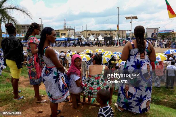 Supporters of Cameroonian President Paul Biya wear clothing emblazoned with his image as they celebrate his re-election in Yaoundé on November 6,...