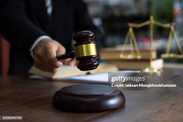 judge gavel with justice lawyers, businessman in suit or lawyer working on a documents. legal law, advice and justice concept. - gavel judge foto e immagini stock