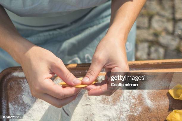 chef preparing handmade stuffed pasta tortellini - ombelico stock pictures, royalty-free photos & images