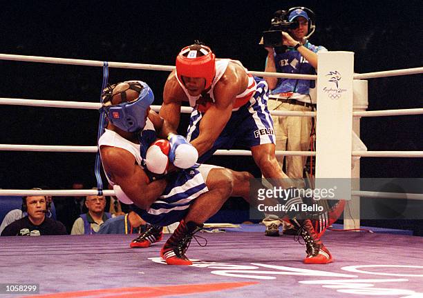 Felix Savon of Cuba falls to the floor during his victory over Michael Bennett of the USA in the 91 kilogram boxing bout held at the Sydney...