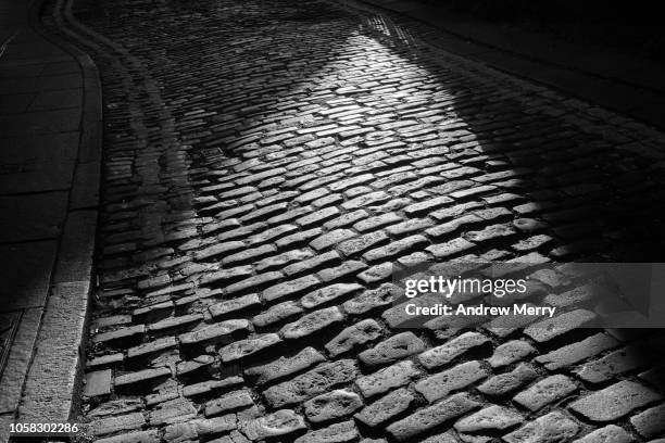 old fashioned paved cobblestone road, edinburgh - edinburgh street stock-fotos und bilder