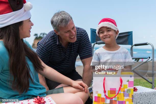 little boy excited to receive a christmas present - new zealand christmas stock pictures, royalty-free photos & images