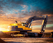 Tracked excavator at the construction site in the evening.
