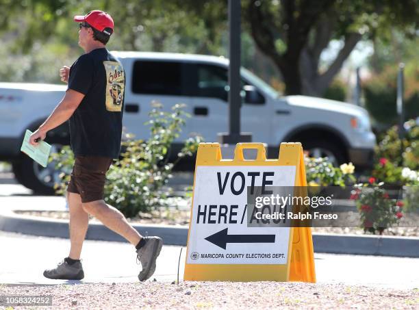 Arizona voters make their way to a polling place to cast their ballot during the midterm elections on November 6, 2018 in Phoenix, Arizona. Arizonans...