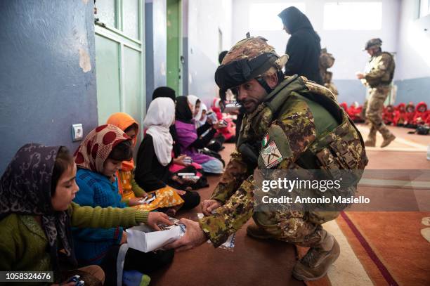 Afghan little girls of the Ansari female orphanage meet the Italian soldiers before to go at school, on November 7, 2018 in Herat, Afghanistan. The...