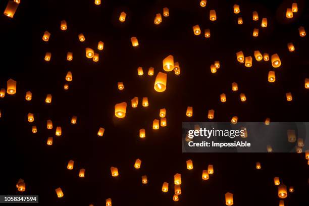 numerous bright lanterns in the sky, yeepeng festival , chiangmai, thailand - jack o lantern fotografías e imágenes de stock