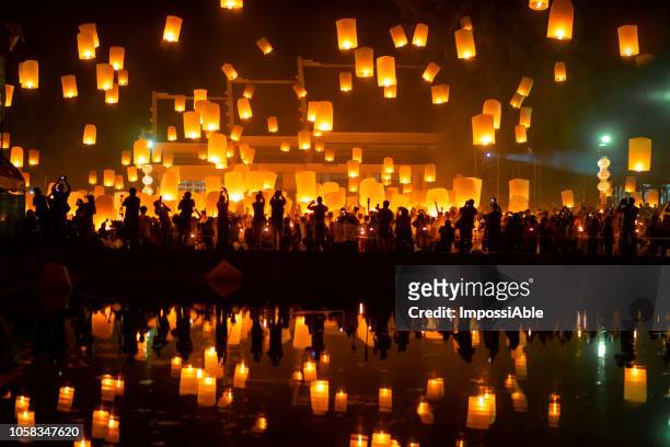 reflection of numerous lanterns in the sky, yeepeng festival , chiangmai, thailand - yi peng - fotografias e filmes do acervo