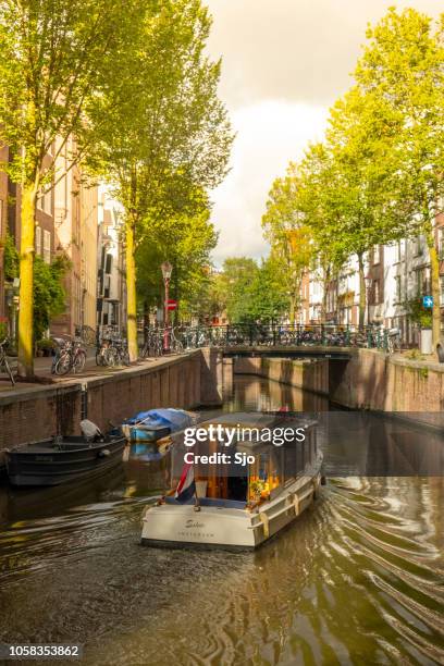 klassieke salon tour boot in de grachten van amsterdam - amsterdam mensen boot stockfoto's en -beelden