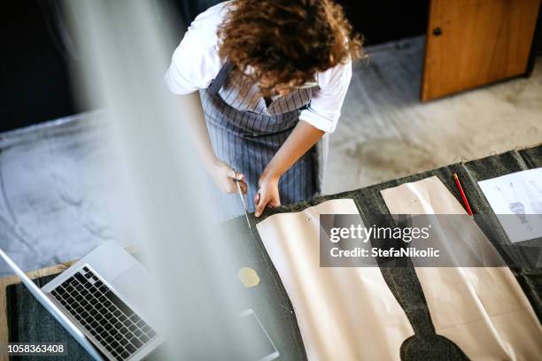 seamstress working in studio - tailor stock pictures, royalty-free photos & images
