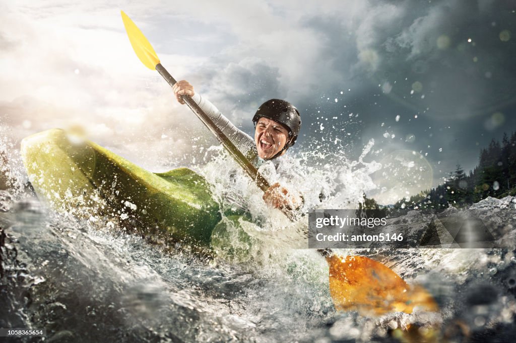 Whitewater kayaking, extreme kayaking. A woman in a kayak sails on a mountain river