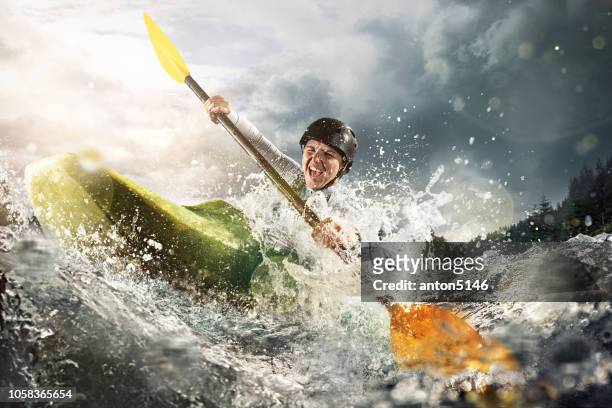 whitewater kayaking, extreme kayaking. a woman in a kayak sails on a mountain river - kayak stock pictures, royalty-free photos & images