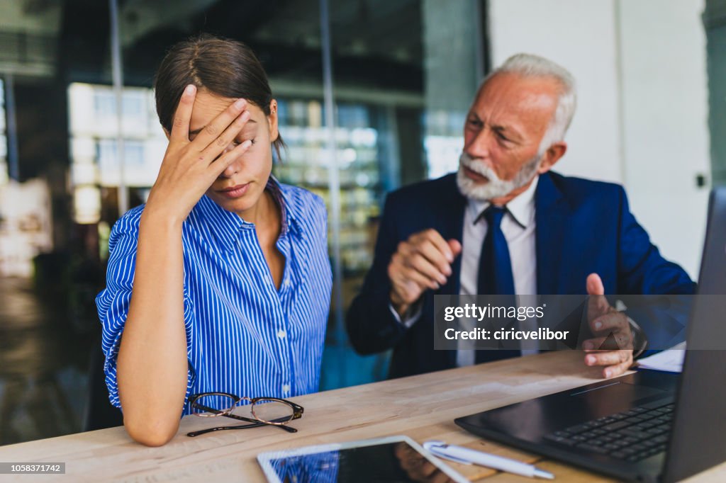 Colleagues arguing at workplace