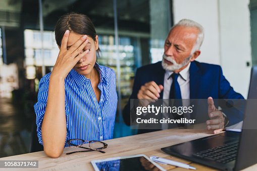 Colleagues arguing at workplace Colleagues arguing at workplace