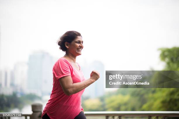 activa mujer mayor disfrutando de un estilo de vida saludable - asiático e indio fotografías e imágenes de stock