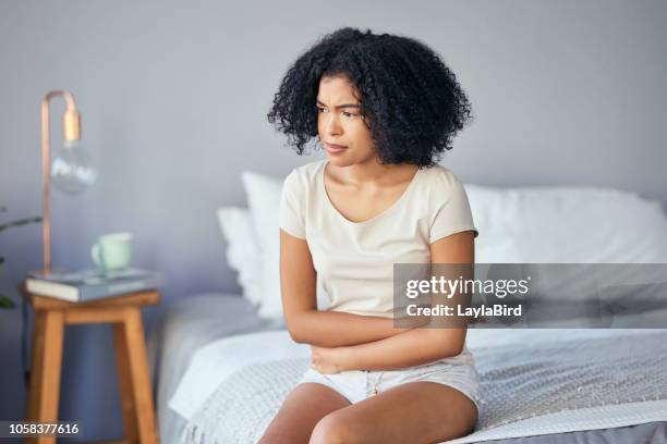 she's a little under the weather - endometriosis images stock pictures, royalty-free photos & images