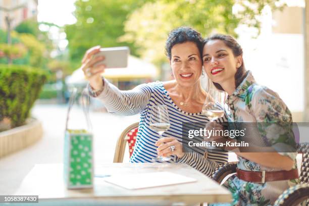 mother and daughter together - mature mother restaurant stock pictures, royalty-free photos & images