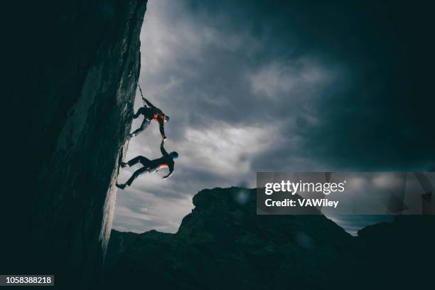 het helpen van een vriend van - team climbing up to mountain top stockfoto's en -beelden