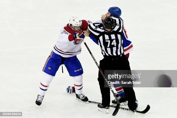 Mike Reilly of the Montreal Canadiens and Cody McLeod of the New York Rangers start a fight but are broken up by the referee during the second period...