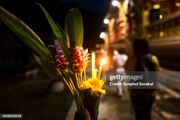 flowers, incense sticks and candles bundle together as an offering during the candlelight procession - religious celebration stock pictures, royalty-free photos & images