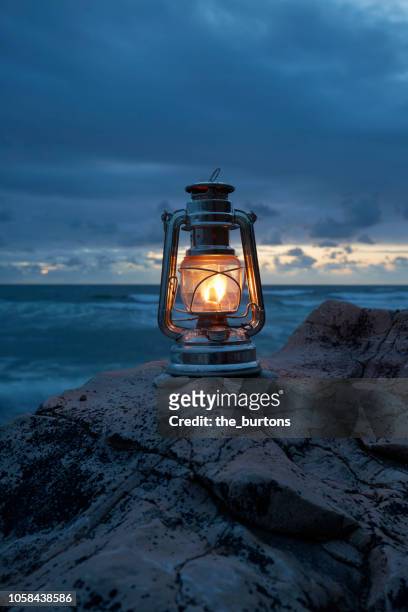 still life of lantern standing on rocks by the sea - lantern imagens e fotografias de stock