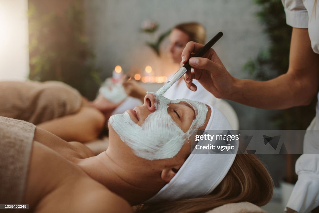 Mother and adult daughter enjoy beauty treatment in a spa center