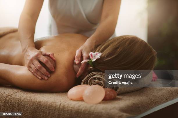 back massage - lastone therapy stock pictures, royalty-free photos & images