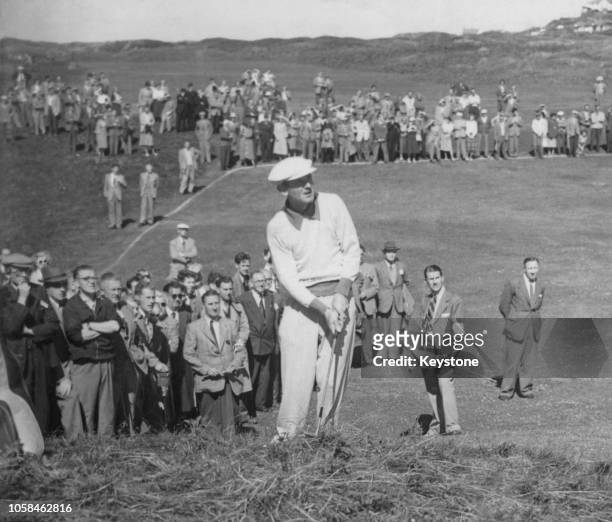Norman Von Nida of Australia chips onto the 9th green from the rough as spectators look on during the 80th Open Championship on 6 July 1951 at the...