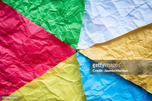 multi colored wrinkled paper background - bosnian rainbows stockfoto's en -beelden