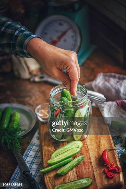 preserving organic cucumbers in jars - pickle relish stock pictures, royalty-free photos & images