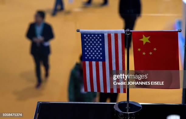 This picture taken on November 6, 2018 shows a Chinese and US flag at a booth during the first China International Import Expo in Shanghai. - There...