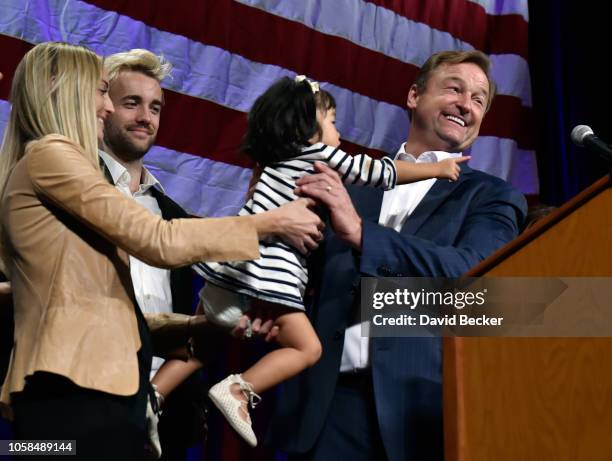 Sen. Dean Heller is handed his granddaughter Ava as he speaks at the Nevada Republican Party's election results watch party at the South Point Hotel...