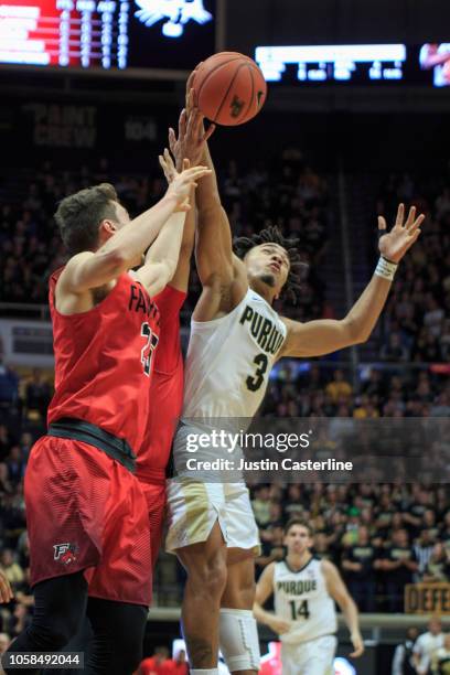 Landon Taliaferro of the Fairfield Stags and Carsen Edwards of the Purdue Boilermakers go up for a rebond in the game against the Fairfield Stags at...