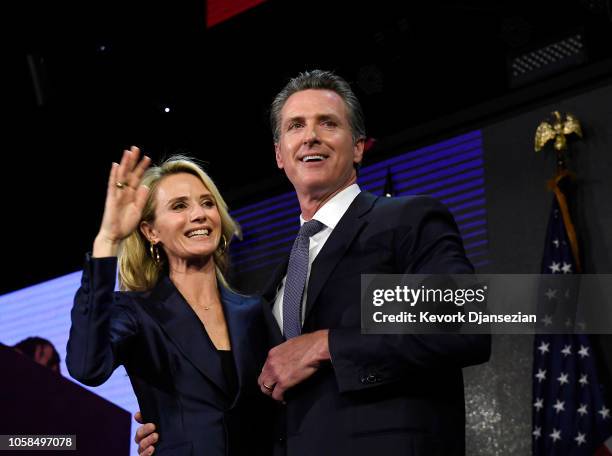 Democratic gubernatorial candidate Gavin Newsom and his wife Jennifer Siebel Newsom wave to supporters during election night event on November 6,...