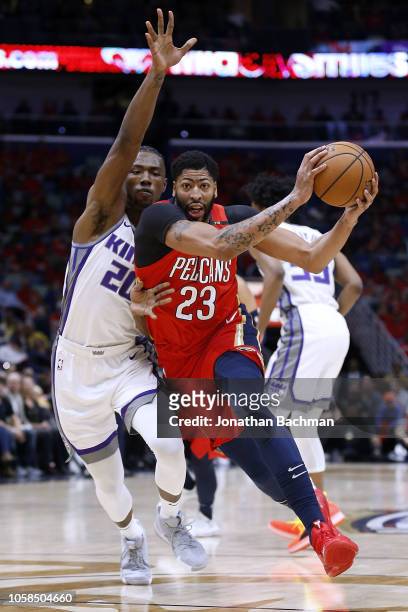 Anthony Davis of the New Orleans Pelicans drives against Harry Giles of the Sacramento Kings during the first half at the Smoothie King Center on...